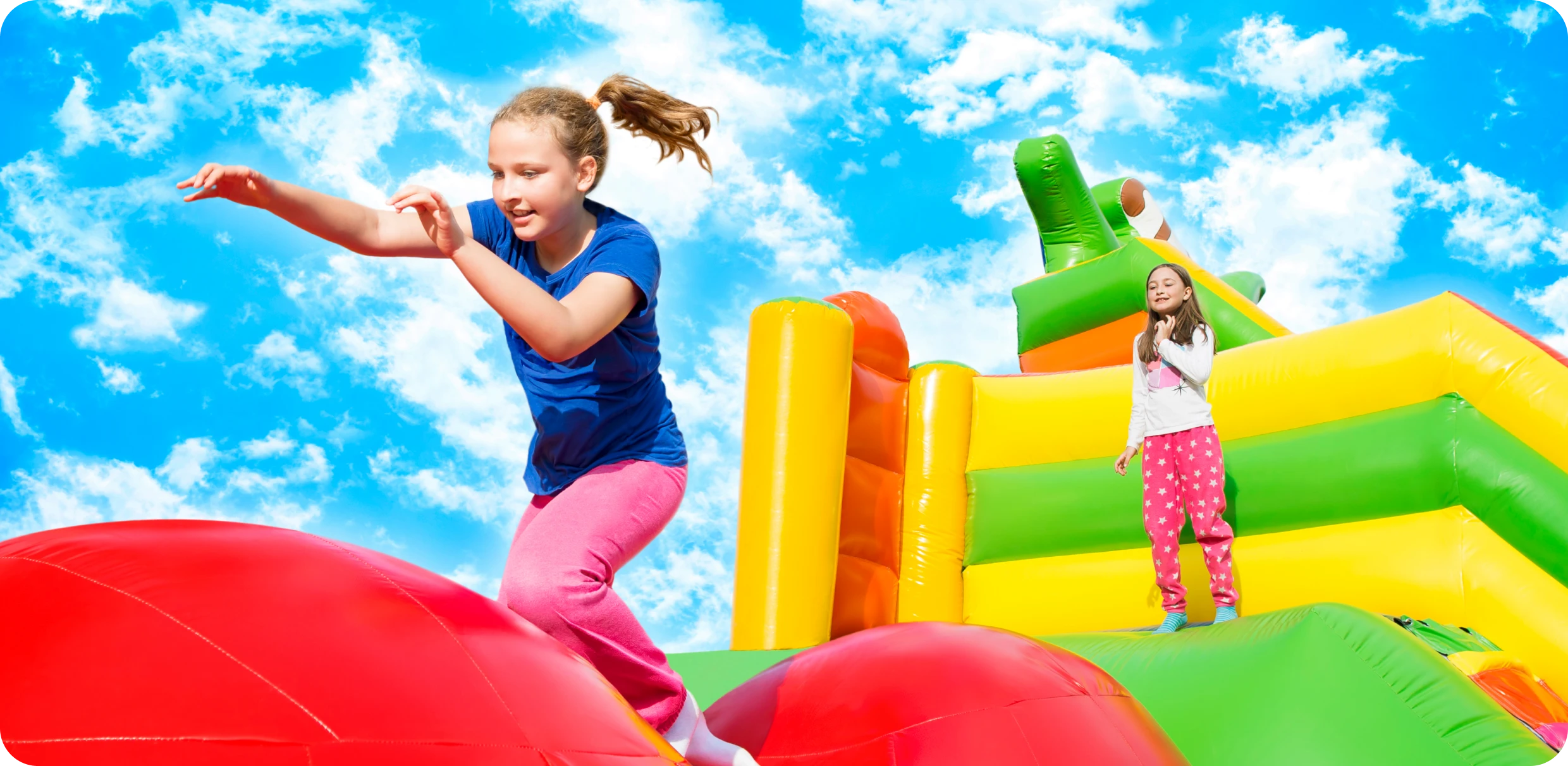 Children playing on colorful inflatable structure